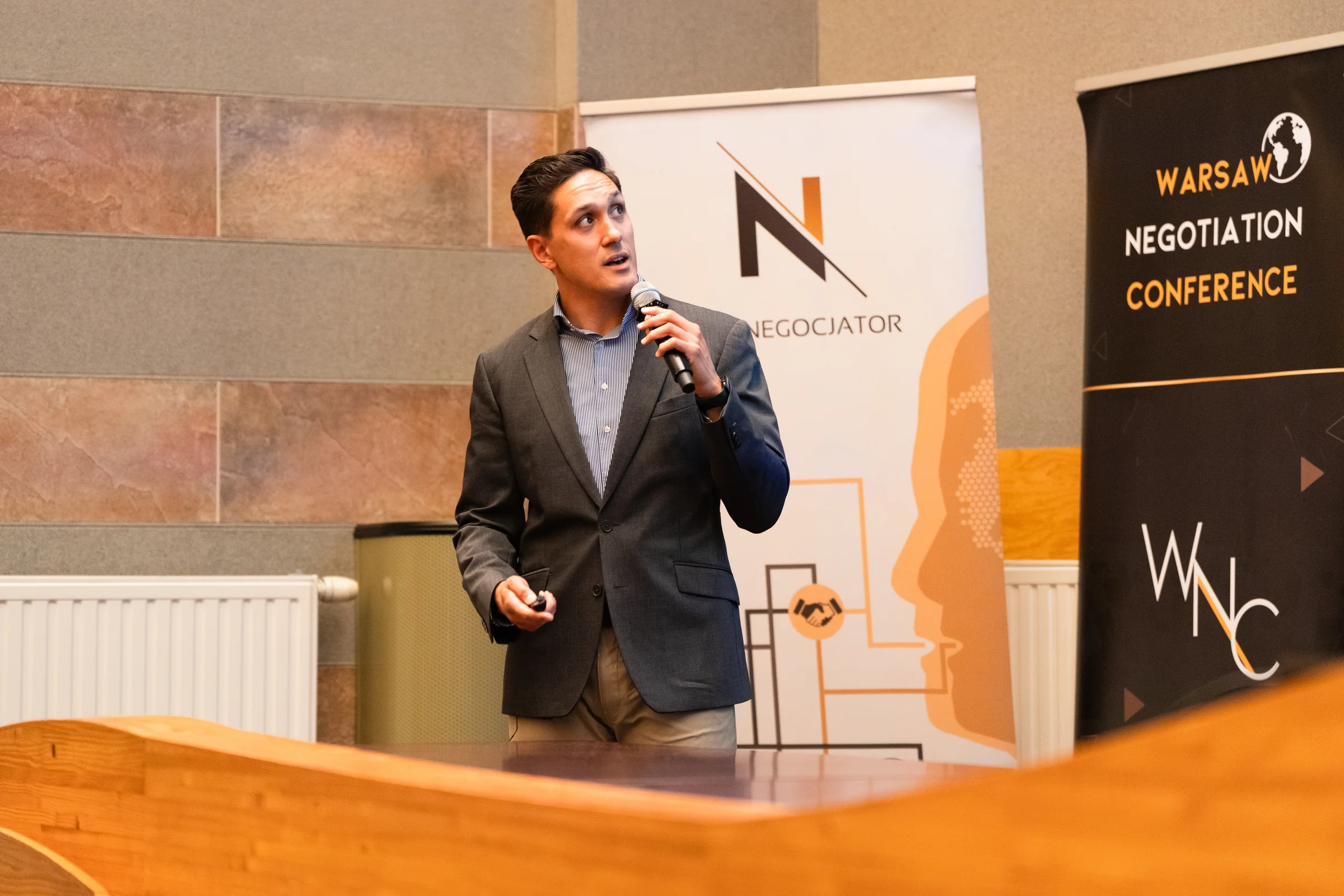 David C. van der Griend speaking with a microphone at the Warsaw Negotiation Conference 2026